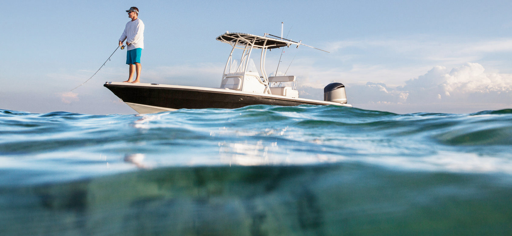Man fishing in the ocean on a boat equipped with marine electronics installed by C&S Marine Electrical in Newport, North Carolina.